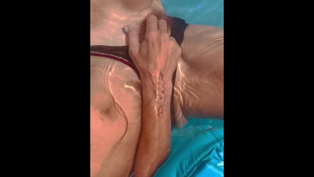 Сексуальная блондинка, возбужденная от солнца и воды, дрочит себя в открытом бассейне и жестко кончает