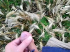 Farmer shows his dirty rubber boots and pee huge in the wheat field