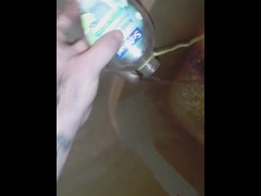 Peeing into a soap bottle