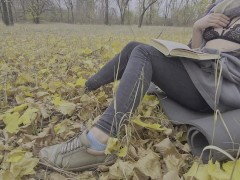 Girl listens to hot stories and caresses herself in the autumn park