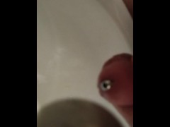 urinating into a sink through a 10mm urethral dilator