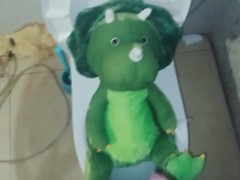 Peeing in green dinosaur