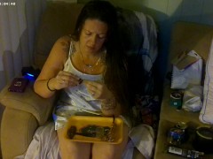 Busty girl in pink bra and panties smoking and playing video games