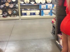 Girl teases in a miniskirt without panties in the store