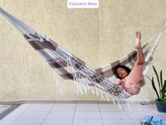 Hot brunette showing off in the backyard and masturbating on the hammock