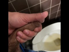 Jerking big limp cock in a public restroom