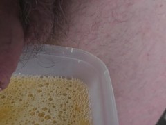 Pissing in a plastic pot