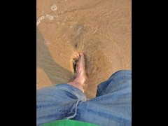 Walking in the water and sand barefoot