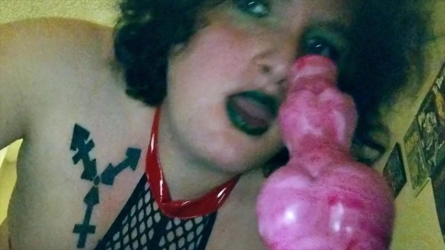 Trans girl in latex sucks on a large werewolf cock