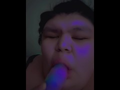 Native girl sucking a multicolored dildo