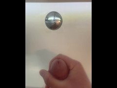 man masturbating in the bathroom sink