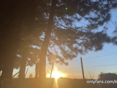 girl peeing with the sunset in the field
