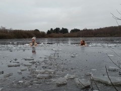 Naked scandinavian Milf and guy has a cold dip in icy lake
