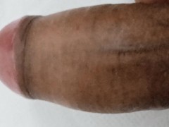 Erect penis in closeup more milk