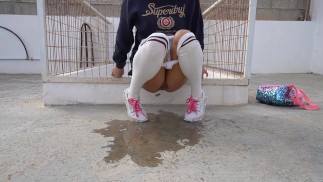 Naughty schoolgirl pees in public