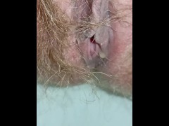 Hairy MILF in white bodysuit pissing close up