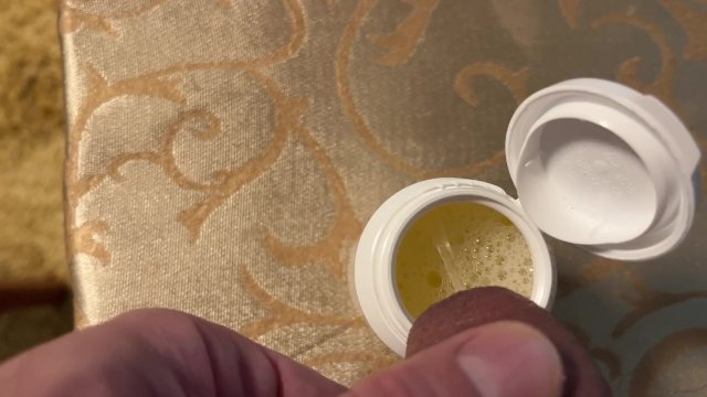 Earl relieves himself in a white container