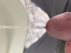 Peeing in a urinal very close up