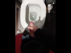 guy in blue jeans jerks off quickly and cums hard in the toilet of a roadside diner