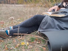 Romantic. Girl reading a book in the park
