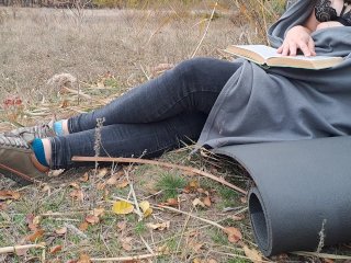 Romantic. Girl reading a book in the park