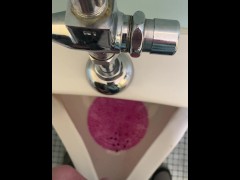 Taking a pee at the urinal after a little day drinking