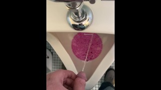Taking a pee at the urinal after a little day drinking