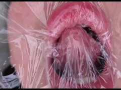 fetish for plastic on the face. close up.