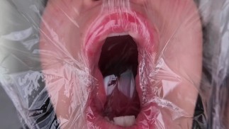 fetish for plastic on the face. close up.