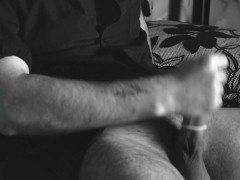 The boy jerks off close-up with a condom and cums loudly into it.