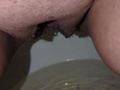 Close up of a piss soaked pussy peeing into a toilet