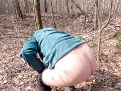 Early spring on bike pissing in the forest near the busy road