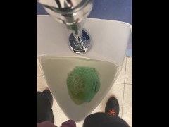 Taking a piss at a urinal