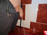 Boy long pissing in a village toilet