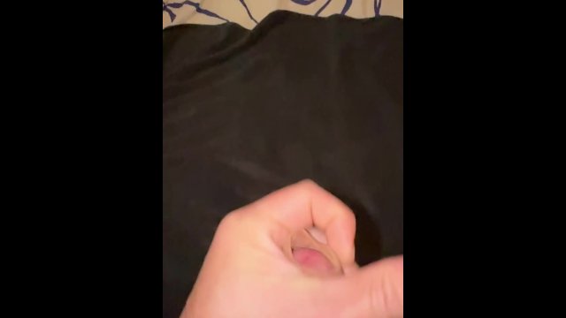 Horny guy in bed masturbates and cums in slow motion