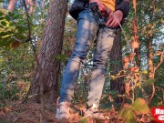 Guy long pissing in the forest under a tree