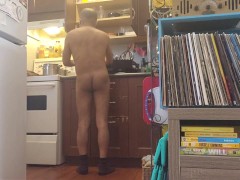 Bachelor undress while doing dishes.
