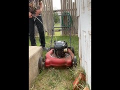 Pissing desperately outside in public on top of a lawn mower