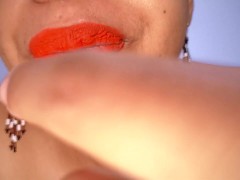 Ebony MILF with red lips eats a fruit suggestively