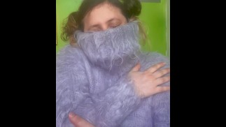 Sweater Goddess Playing with a Fuzzy Blue Mohair Turtleneck