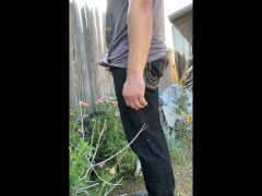 Taking a very long sneaky desperate public piss next to some flowers very close to neighbors
