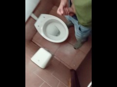 young smooth chav guy in blue jeans and sneakers jerks off his cock in a public toilet