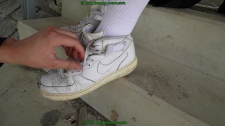 cutting black and white nike af1 mid from slaves feet