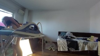 Amateur mom does chores in the naked house.
