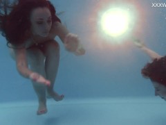 Girlfriends enjoy swimming naked together