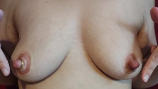 Playing with my hard pumped nipples. Wich do you prefer: pierced or not?